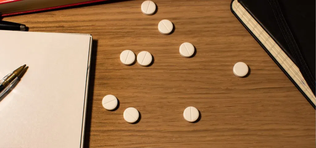 adderall pills on college students desk