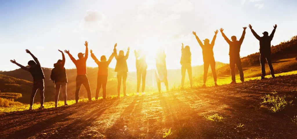 line of people with arms up knowing what is community housing