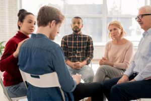 men and women in group Addiction Treatment Therapies