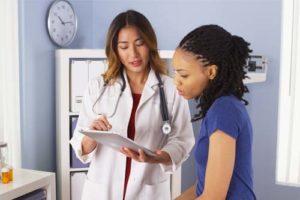 doctor going over chart with woman at the Partial Hospitalization Program in OH