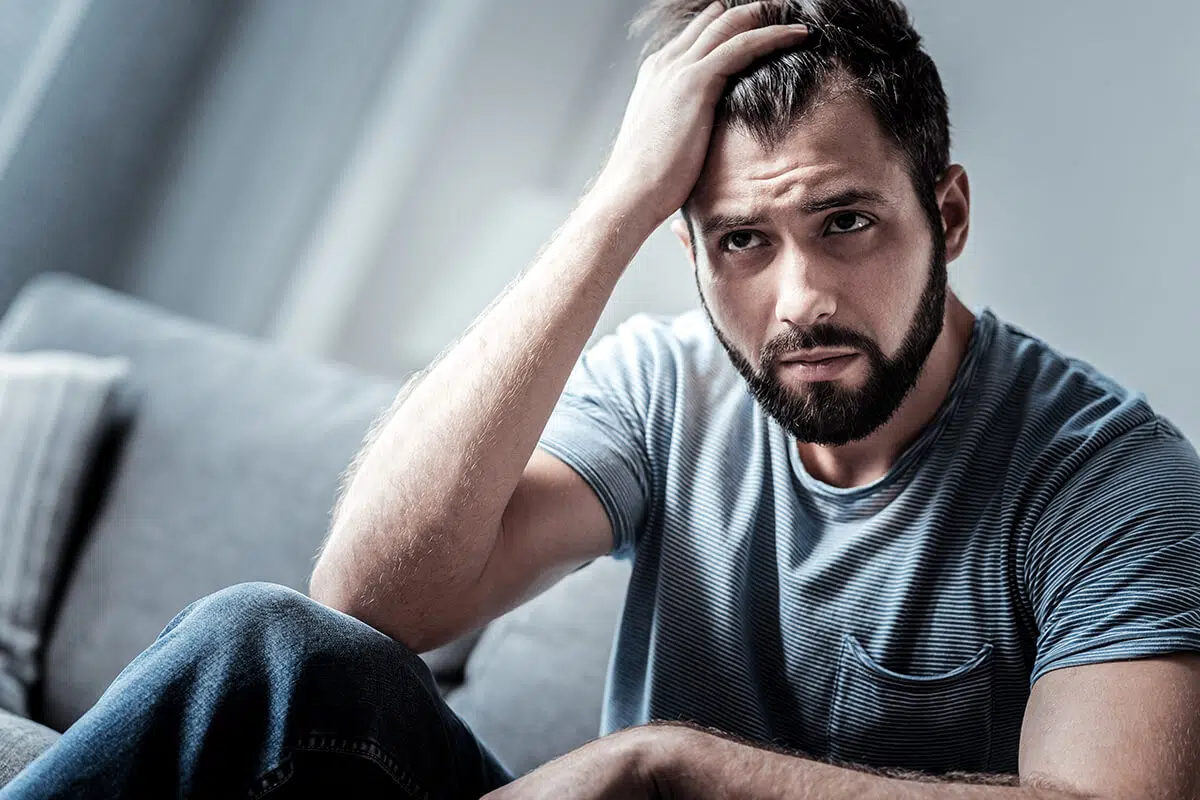 distraught man going through Alcohol Withdrawal Symptoms
