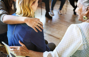 therapist and group member comforting woman in Group Therapy Program
