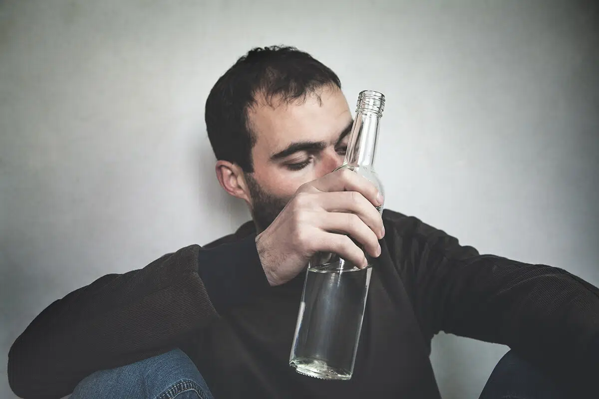 man with bottle of alcohol that is a drug