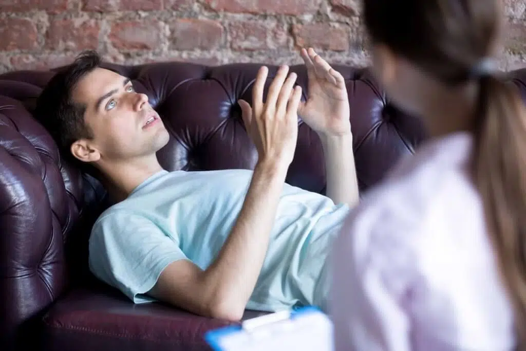 man laying on couch during counseling asking What Is Trauma Therapy