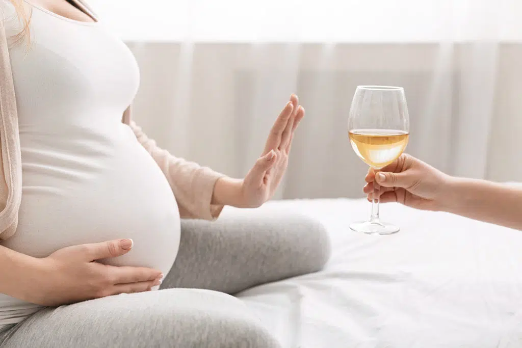 pregnant woman refusing wine to refrain from drinking while pregnant
