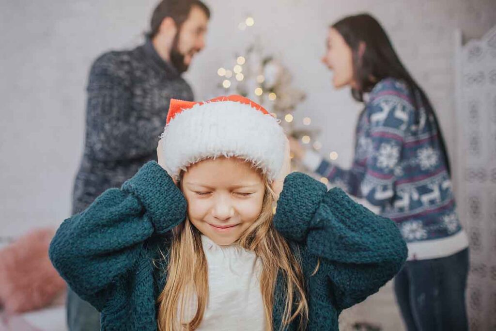 child caught between two arguing parents during christmas needing midwest family therapy