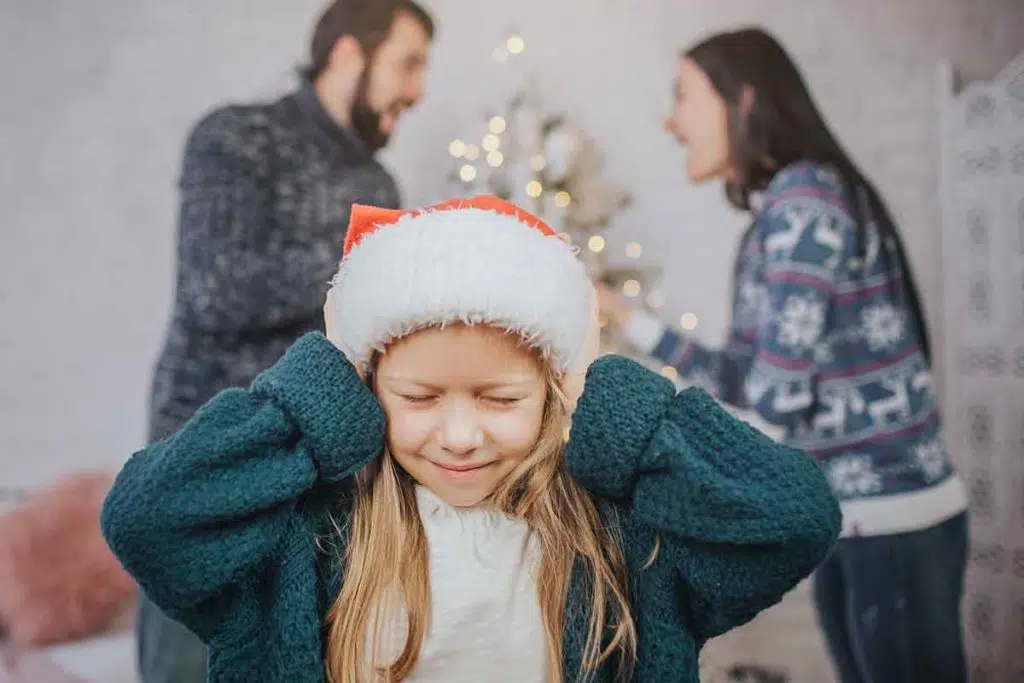 child caught between two arguing parents during christmas needing midwest family therapy