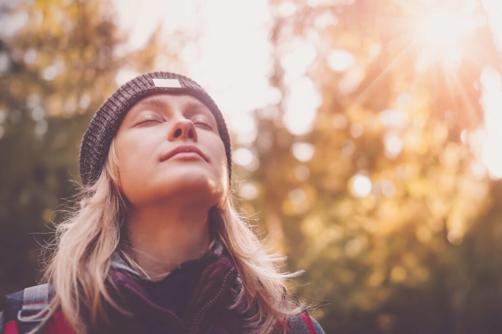 person outside detox letting sun hit their face