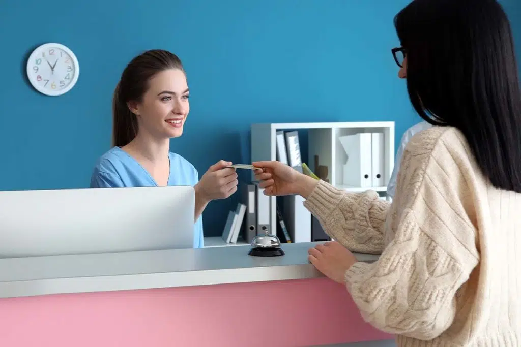 woman pays for her rehab treatment