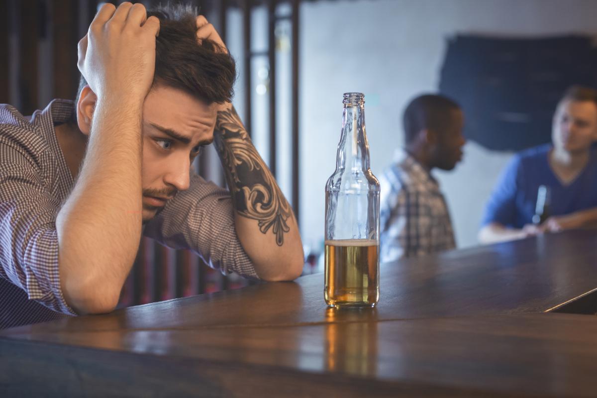 man suffers from the side effects of alcohol addiction