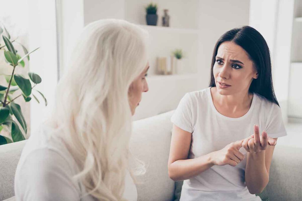 two people talking about addiction childhood trauma on couch