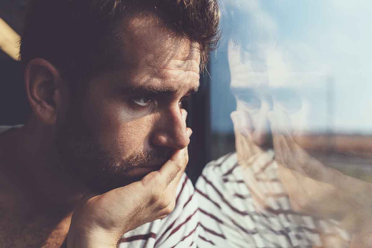 person staring out window dealing with long term effects of heroin