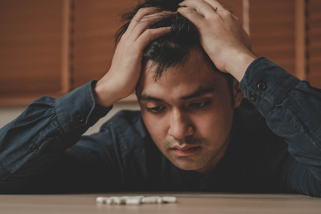 person staring at medications wondering xanax abuse and depression